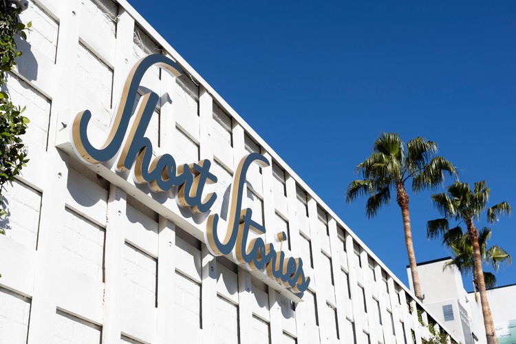 View of Exterior of Hotel with Short Stories sign and palm trees